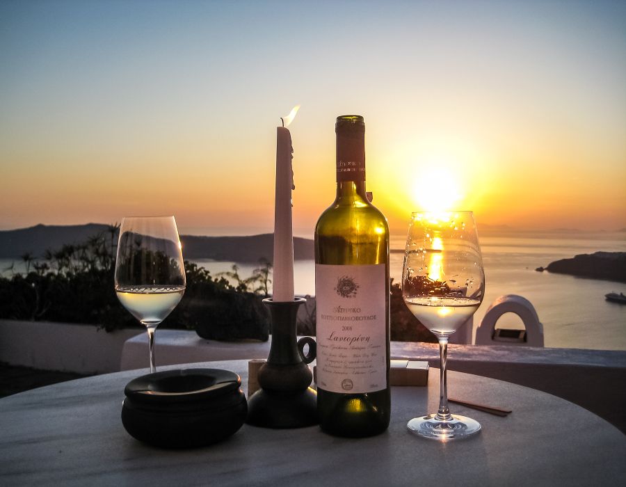 Sunset and Assyrtiko wine in Santorini